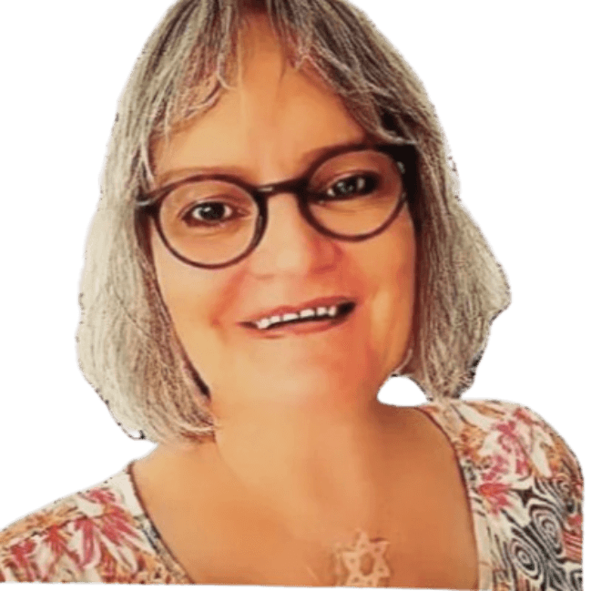 Smiling woman with short grey hair, round glasses, and a Star of David necklace.